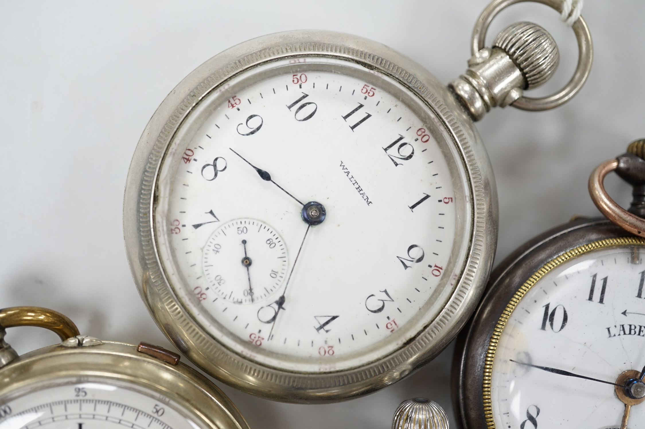 Ten assorted base metal pocket watches including Omega, Waltham and Ingersoll.